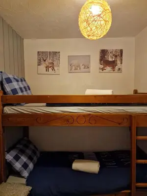 a bunk bed in a room with a chandelier at Etoile des Alpes in Saint-Gervais-les-Bains