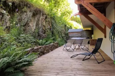 a patio with chairs and a table on a wooden deck at Cocoon In Megève in Megève