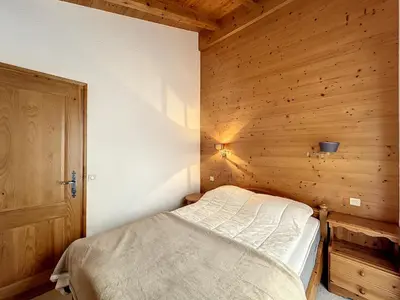 a bedroom with a bed in a wooden room at Appartement 3 pièces proche pistes à Combloux avec parking - FR-1-560-117 in Combloux
