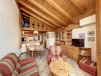a living room with a table and chairs and a kitchen at Appartement 3 pièces proche pistes à Combloux avec parking - FR-1-560-117 in Combloux