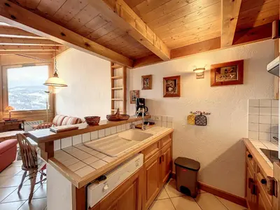a kitchen with a sink and a table in a room at Appartement 3 pièces proche pistes à Combloux avec parking - FR-1-560-117 in Combloux