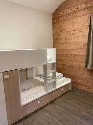 a bedroom with a bed in a wooden wall at Chalet Cristal II in Les Contamines-Montjoie