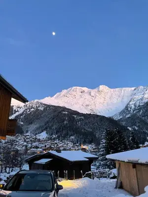 a car parked in the snow in front of a mountain at Chalet Cristal II in Les Contamines-Montjoie