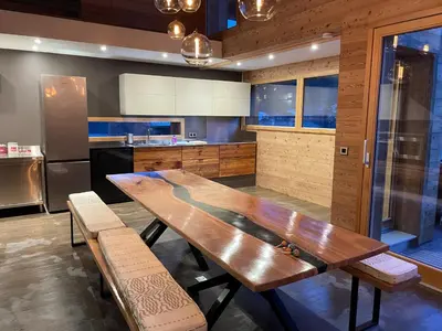a large kitchen with a wooden table and benches at Chalet Cristal II in Les Contamines-Montjoie