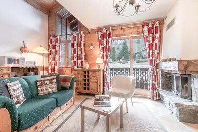 a living room with a couch and a fireplace at Les Grandes Jorasses - Calme - Duplex in Les Houches