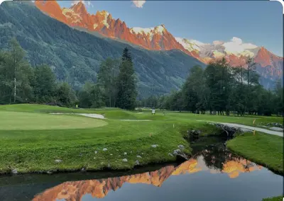 a golf course with a reflection of a mountain at Andro in Chamonix-Mont-Blanc