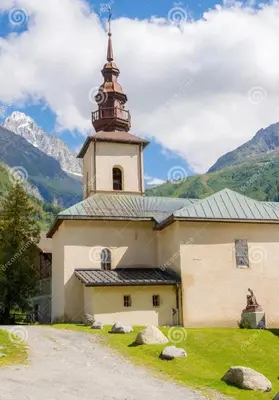 a church with a tower and a steeple at Andro in Chamonix-Mont-Blanc
