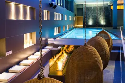 a swimming pool with chairs and a swing at Andro in Chamonix-Mont-Blanc