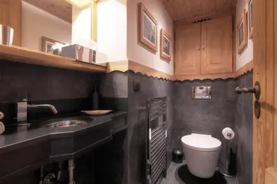 a bathroom with a sink and a toilet in it at Duplex Chaleureux au Cœur de Megève 2 p in Megève