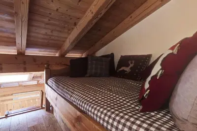 a bed in a room in a log cabin at Duplex Chaleureux au Cœur de Megève 2 p in Megève