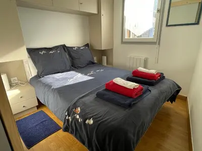 a bedroom with a bed with two pillows on it at Resort central apartment ideal for up to 2 people in Les Carroz d'Araches