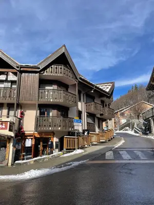 a building on the side of a street with a road at Resort central apartment ideal for up to 2 people in Les Carroz d'Araches