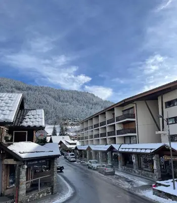 a street in a town with snow covered buildings at Resort central apartment ideal for up to 2 people in Les Carroz d'Araches