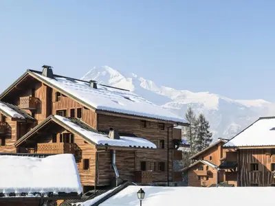 a group of wooden buildings with snow covered roofs at Résidence Les Fermes du Soleil - maeva Home - Appartement 3 Pièces 6 Personnes - Sélection MAE-1543 in Arâches-la-Frasse