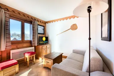 a living room with a couch and a tv at Résidence Les Fermes du Soleil - maeva Home - Appartement 3 Pièces 6 Personnes - Sélection MAE-1543 in Arâches-la-Frasse