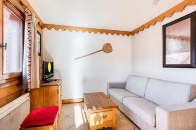 a living room with a couch and a table at Résidence Les Fermes du Soleil - maeva Home - Appartement 3 Pièces 6 Personnes - Sélection MAE-1543 in Arâches-la-Frasse