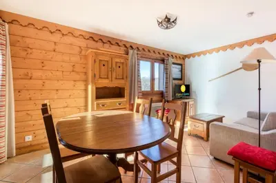 a living room with a table and a couch at Résidence Les Fermes du Soleil - maeva Home - Appartement 3 Pièces 6 Personnes - Sélection MAE-1543 in Arâches-la-Frasse