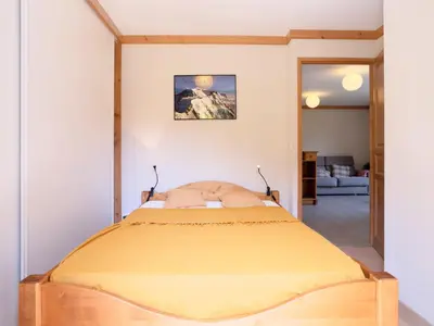a living room with a table and a couch at Apartment Clos de la Fontaine 1 by Interhome in Saint-Gervais-les-Bains