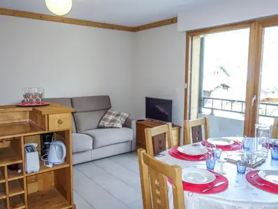 a kitchen with wooden cabinets and a sink at Apartment Clos de la Fontaine 1 by Interhome in Saint-Gervais-les-Bains