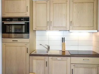 a kitchen with a counter top with a book on it at Apartment Clos de la Fontaine 1 by Interhome in Saint-Gervais-les-Bains