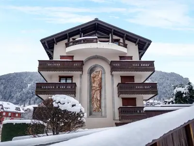 a small town in the mountains with cars parked at Apartment Jardins Alpins 2 by Interhome in Saint-Gervais-les-Bains