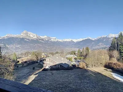 an aerial view of a house with mountains in the background at Duplex 3 pièces au cœur de Combloux, proche navette ski, balcon Mont Blanc, parking et casier à skis - FR-1-560-120 in Combloux