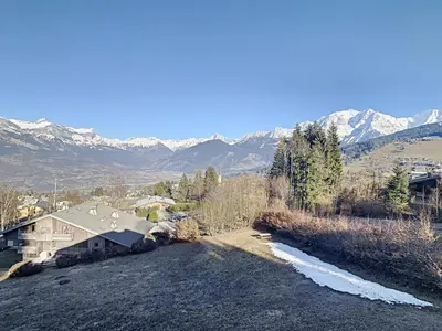 an aerial view of a house with mountains in the background at Duplex 3 pièces au cœur de Combloux, proche navette ski, balcon Mont Blanc, parking et casier à skis - FR-1-560-120 in Combloux