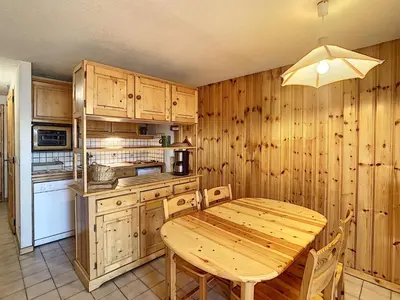 a wooden kitchen with a wooden table and chairs at Duplex 3 pièces au cœur de Combloux, proche navette ski, balcon Mont Blanc, parking et casier à skis - FR-1-560-120 in Combloux