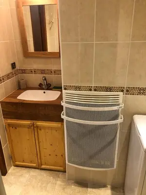 a bathroom with a sink and a toilet and a mirror at Princesse jonquille in Demi-Quartier