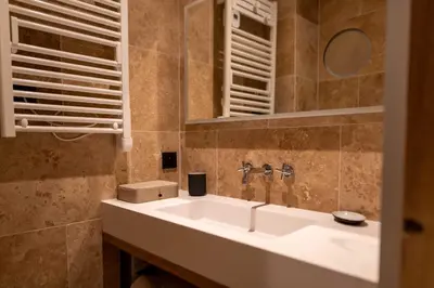 a bathroom with a sink and a mirror at Apartment with terrace and parking heart of Megève in Megève