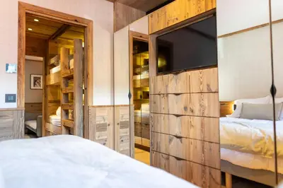 a bedroom with a bed and a large sliding barn door at Apartment with terrace and parking heart of Megève in Megève