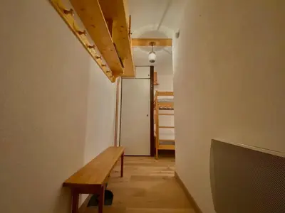 a hallway with a wooden bench and a refrigerator at Studio cosy rénové avec balcon et animaux acceptés, centre de Samoëns - FR-1-624-157 in Samoëns