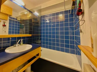 a blue tiled bathroom with a sink and a tub at Studio cosy rénové avec balcon et animaux acceptés, centre de Samoëns - FR-1-624-157 in Samoëns