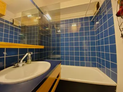 a blue tiled bathroom with a sink and a tub at Studio cosy rénové avec balcon et animaux acceptés, centre de Samoëns - FR-1-624-157 in Samoëns