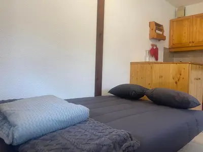 a bedroom with two pillows on a bed at Studio cosy rénové avec balcon et animaux acceptés, centre de Samoëns - FR-1-624-157 in Samoëns