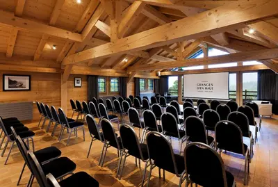 a conference room with chairs and a screen in it at Les Granges d'en Haut - Chamonix Les Houches in Les Houches