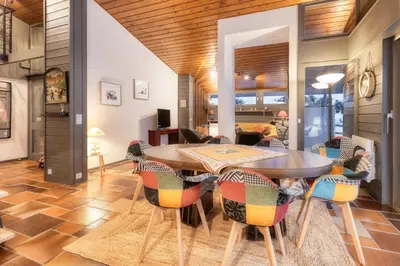 a dining room with a table and chairs at Luméa - Chalet vue sur le Mont Blanc in Saint-Gervais-les-Bains