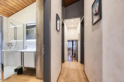 a hallway leading to a bathroom with a sink at Luméa - Chalet vue sur le Mont Blanc in Saint-Gervais-les-Bains