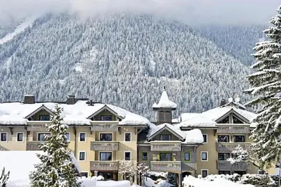 a large building with snow on top of it at Résidence La Ginabelle - maeva Home - Appartement 3 pièces 6 personnes - Sélection MAE-2964 in Chamonix-Mont-Blanc