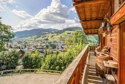 a balcony with a view of a city at SOMPTUEUX CHALET BARON MEGEVE VUE.Jaccuzi.4 mn a pied au centre in Megève