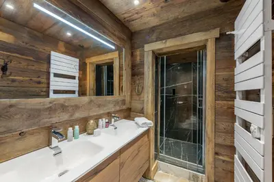 a bathroom with a sink and a shower at SOMPTUEUX CHALET BARON MEGEVE VUE.Jaccuzi.4 mn a pied au centre in Megève