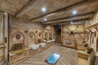a room with benches in a room with wooden walls at SOMPTUEUX CHALET BARON MEGEVE VUE.Jaccuzi.4 mn a pied au centre in Megève