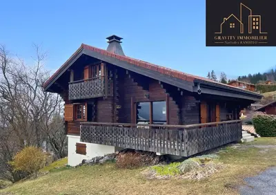 a wooden house with a balcony on a hill at Chalet 4 pièces + Mezzanine , Les Carroz in Les Carroz d'Araches