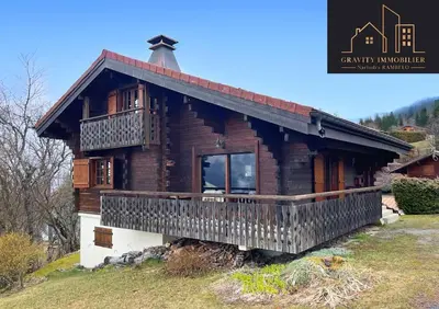 a log cabin with a porch and a balcony at Chalet 4 pièces + Mezzanine , Les Carroz in Les Carroz d'Araches