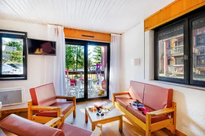 a living room with two chairs and a table at Village Club Les Tavaillons in Les Carroz d'Araches