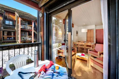 a screened in porch with a view of a living room at Village Club Les Tavaillons in Les Carroz d'Araches