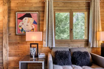 a living room with a couch and a window at Appartement Chalet à Megève in Megève