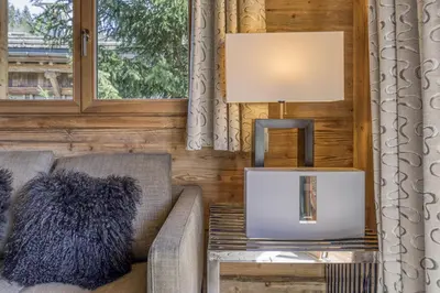 a living room with a couch and a table at Appartement Chalet à Megève in Megève