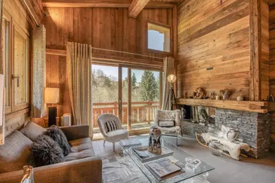 a living room with a couch and a fireplace at Appartement Chalet à Megève in Megève
