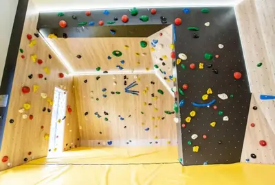 a climbing wall in a gym with a rock wall at La Belle Cordee SPA lujo y piscina CHAMONIX in Chamonix-Mont-Blanc